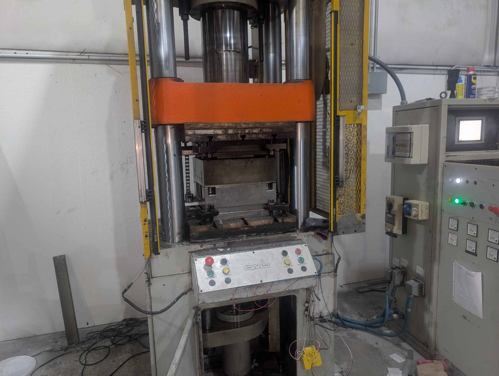 Italian-built OMB hydraulic press with Italian-labelled pendant controls, SICK light curtains and its original control cabinet