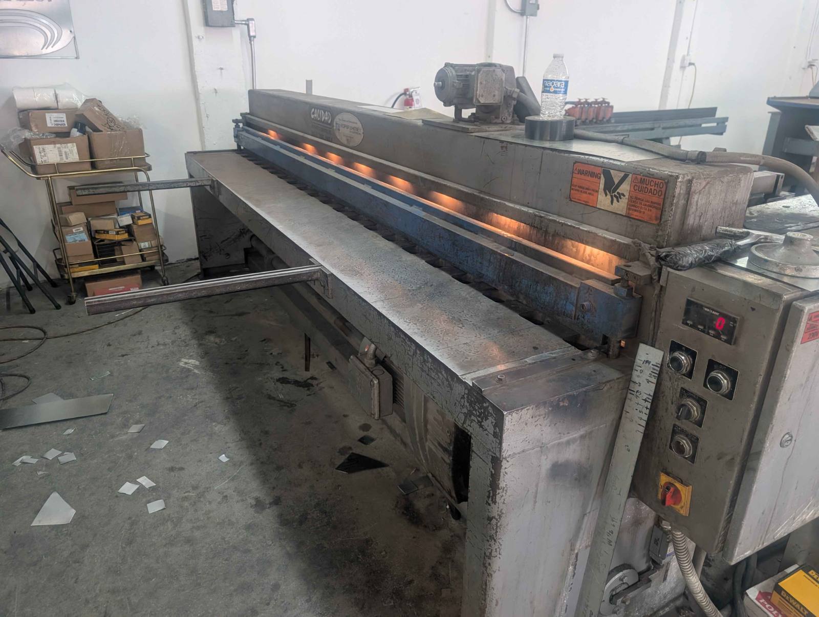 Whitney squaring shear on a plant floor with back gauge, control station and offcuts