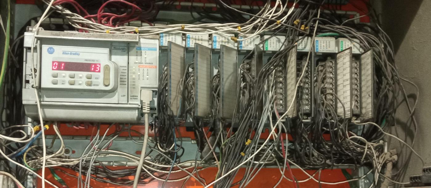 Allen-Bradley MicroLogix 1500 processor and I/O rack in an older control cabinet, with the battery compartment at the end of the controller